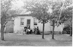 Six people in front of  the Pickett Octagonal House, now 6103 Guelph Line, ca 1900