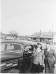 George Wickens and an unidentified woman and man in front of the George H. Sinclair store at the intersection of  Plains Road and La Salle Park Road, ca 1940