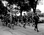 Ist Company Burlington Boy Scouts on parade with scoutmaster George Johnson, 1950