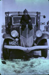 Boy Sitting on the hood of a Big Lumber Truck