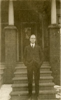 Dr. George C.R. Hall Standing by Residence