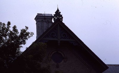 Barge board, round window, brick work, unknown location