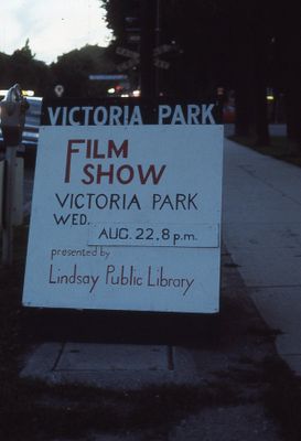 Sign advertising outdoor film showing, a library program, 1973