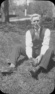 Portrait of an older man holding a kitten