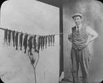 Man with a display of his fishing net and catch