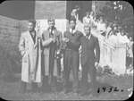 Portrait of a group of young men including Jack Armstrong, Jack Alfred Seed and Bill Griffis in front of Colborne High School holding a trophy