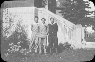 Portrait of three young men in front of Colborne High School