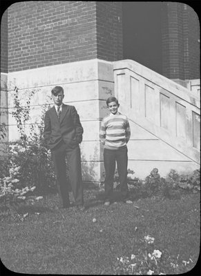 Portrait of two young men in front of Colborne High School