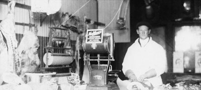 A butcher in his shop preparing meat, Colborne