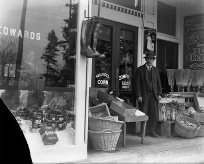 Charles Brown? in front of W.H. Edwards grocery store, Victoria Square, Colborne