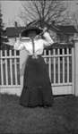 Woman posing in front of a home