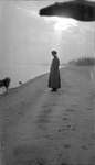 Woman standing in profile at the shoreline