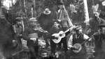 An outdoor scene of a group of men playing instruments