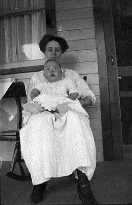 Mother and child resting on a porch