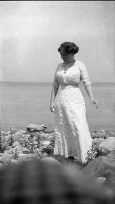 A woman standing on the shoreline