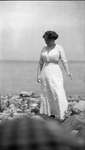 A woman standing on the shoreline