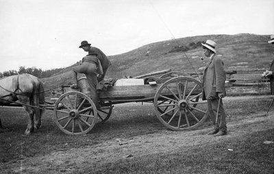 Three men and a horse drawn wagon