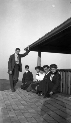 A group of young men and women on a porch roof