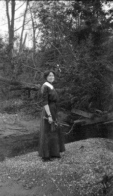 A woman standing near the woods