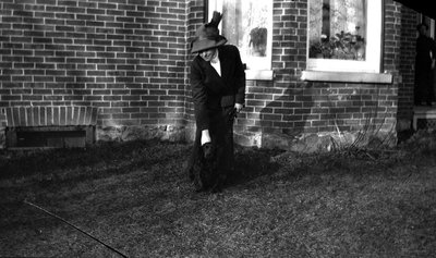 A woman standing in front of house with her dog