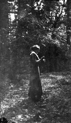 A young woman standing in the woods