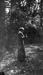 A young woman standing in the woods