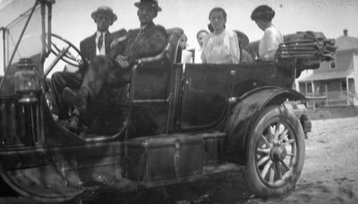 A group of young men and women in a car