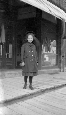 Helen Yeomans standing in front of a store, Colborne