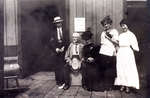 Reproduction photograph of John Monroe Black, George I. Merriman, Ella Jane (nee Merriman) Black, unidentified young woman, and Hattie Edna (nee Black) Kerr, Grand Trunk Railway Station, Colborne
