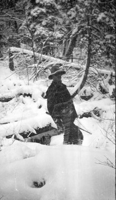 A deer hunter standing in the snow