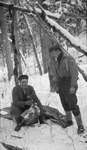 Two deer hunters with slain deer