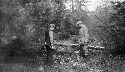 Two deer hunters in the woods