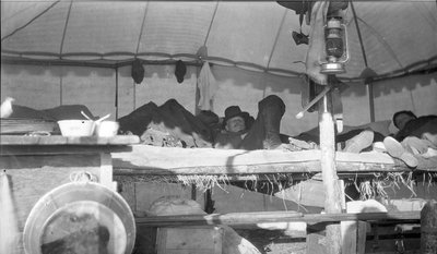 Deer hunters resting inside their camp tent