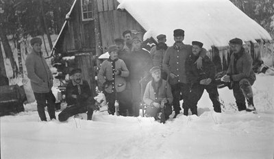 Deer hunters posing outside of their winter camp