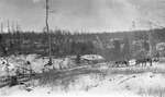 Deer hunters transporting their gear by a horse drawn sleigh