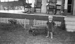 A young boy with his wagon outside the Griffis' summer house