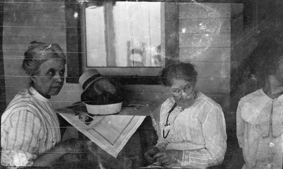 Women resting on the porch of the Griffis' summer house