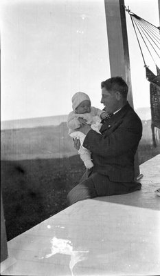 Father and child on the porch of the Griffis' summer house