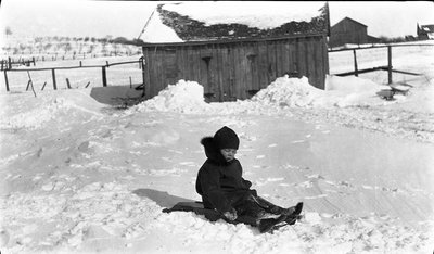 A young Griffis? boy on his sled