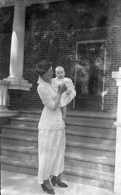 Griffis family photo of a mother and baby in front of a house