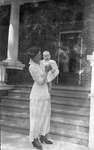 Griffis family photo of a mother and baby in front of a house