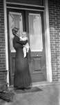 Griffis family photo of an elderly woman and baby at front doorway