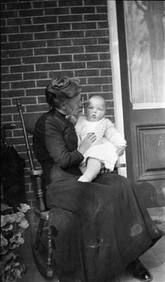 Griffis family photo of elderly woman and baby seated on a porch