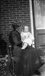 Griffis family photo of elderly woman and baby seated on a porch