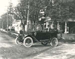 Photograph of a young boy driving two men, Chief Jamieson and possibly Frank Griffis, in a 1910s car, Colborne, Cramahe Township