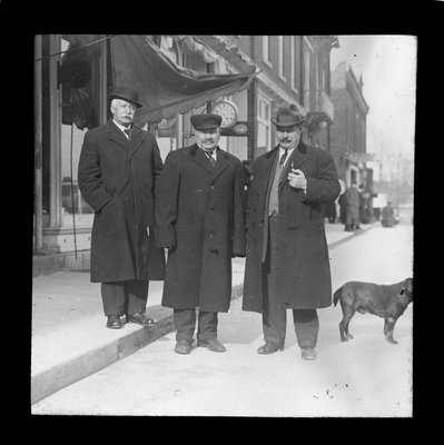 Three men standing in front of a jewellery store, King Street, Colborne