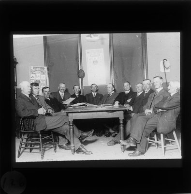 Twelve men at a meeting