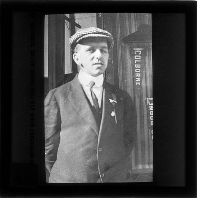 A man standing in front of Colborne banners