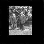 Two men standing in a backyard