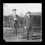 Two men standing on a lawn